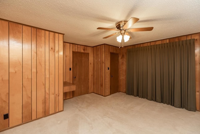 190 Magnolia Trl, Lumberton, TX 77657 - unfurnished room with carpet flooring, a ceiling fan, wooden walls, and a textured ceiling
