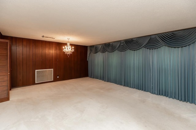 190 Magnolia Trl, Lumberton, TX 77657 - carpeted spare room featuring a chandelier and wood walls