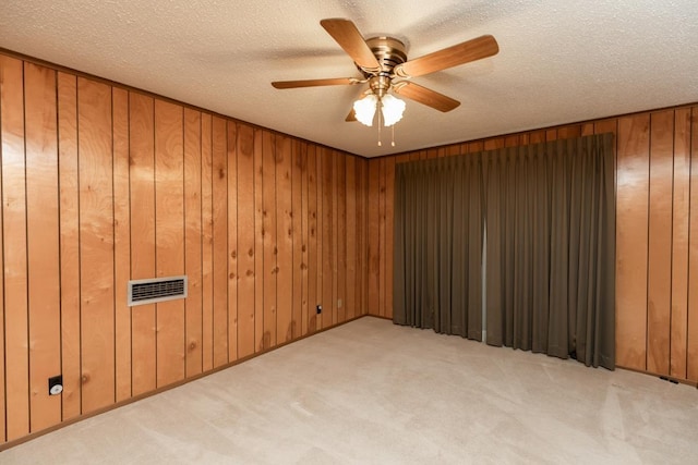 190 Magnolia Trl, Lumberton, TX 77657 - carpeted spare room featuring wooden walls, a ceiling fan, and a textured ceiling