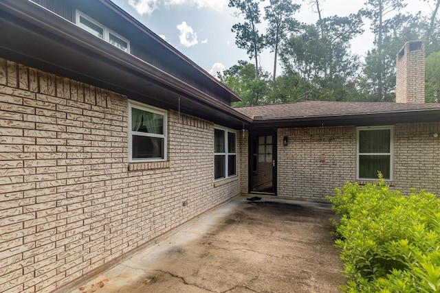 190 Magnolia Trl, Lumberton, TX 77657 - property entrance featuring brick siding, a chimney, and a patio