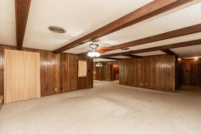 190 Magnolia Trl, Lumberton, TX 77657 - unfurnished living room with beam ceiling, wood walls, carpet, and ceiling fan