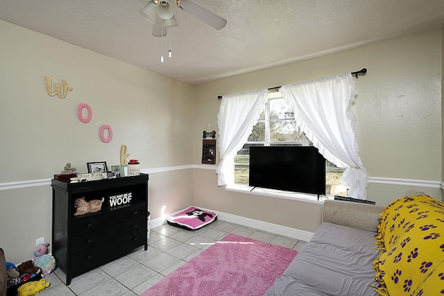 11 Finwick Dr, Orange, TX 77632 - living area with baseboards, a ceiling fan, a textured ceiling, and light tile patterned flooring