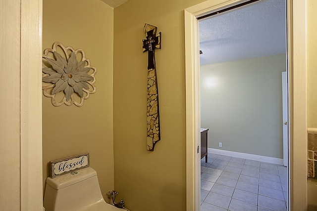 11 Finwick Dr, Orange, TX 77632 - half bath with baseboards, a textured ceiling, toilet, and tile patterned floors