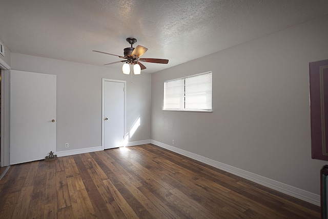 11 Finwick Dr, Orange, TX 77632 - spare room featuring a ceiling fan, a textured ceiling, baseboards, and dark wood-style flooring