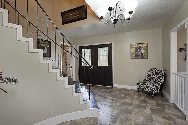 11 Finwick Dr, Orange, TX 77632 - entryway with a textured ceiling, stairway, a chandelier, and baseboards