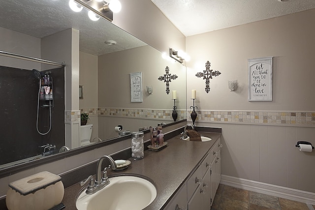 11 Finwick Dr, Orange, TX 77632 - bathroom with a textured ceiling, wainscoting, and a sink
