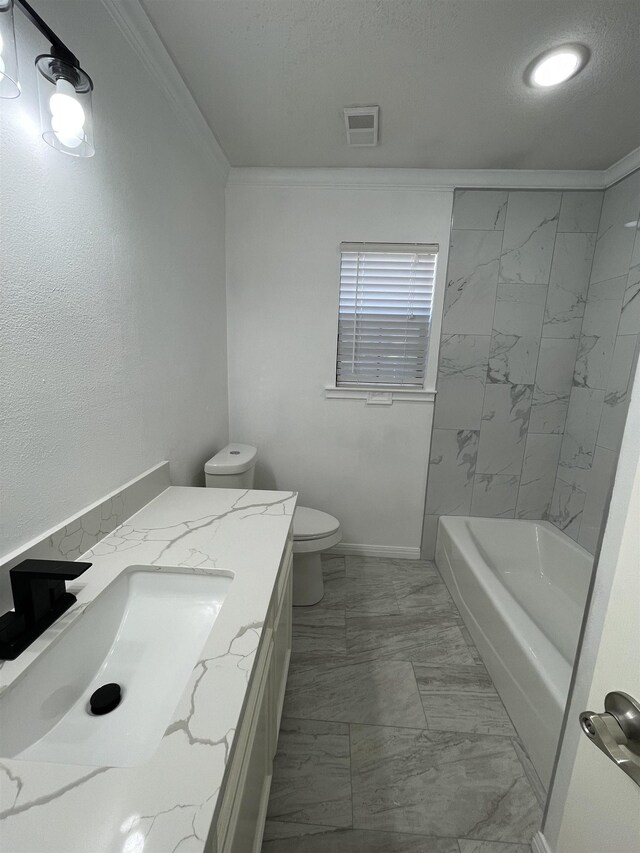 full bathroom with toilet, vanity, crown molding, and tiled shower / bath