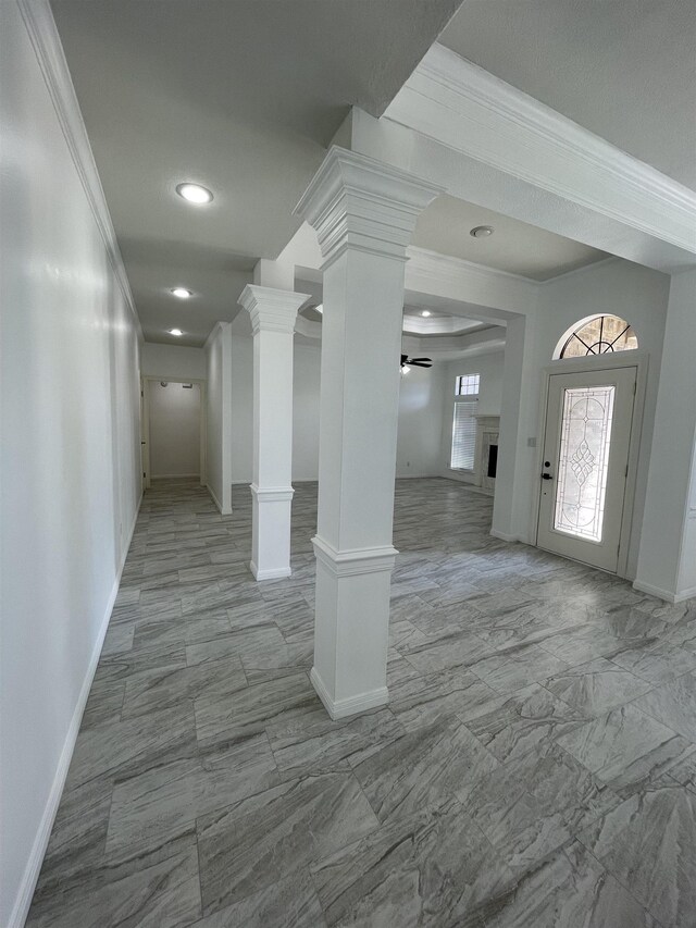 foyer entrance with ceiling fan and ornamental molding