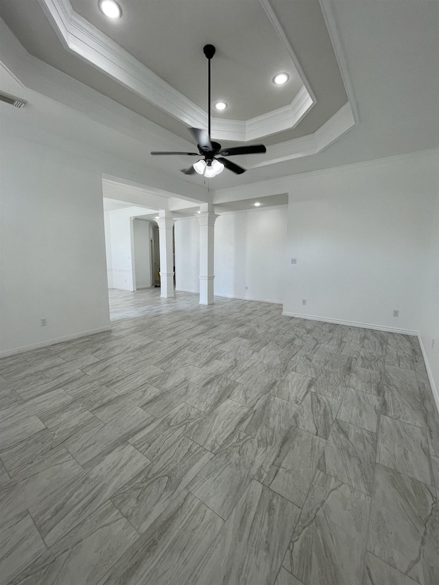 spare room featuring ceiling fan, ornamental molding, and a tray ceiling