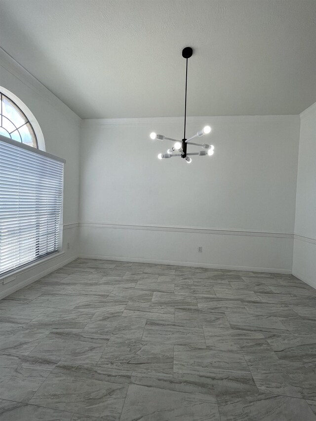 unfurnished dining area featuring a chandelier