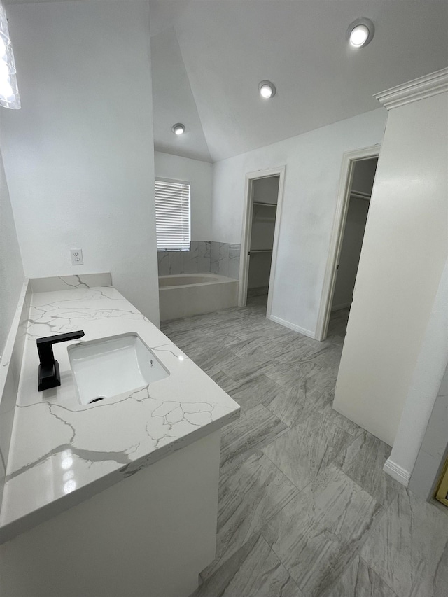 kitchen with lofted ceiling, kitchen peninsula, sink, and light stone counters