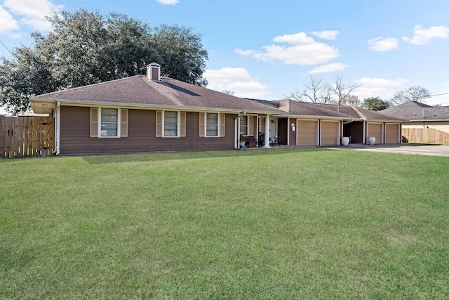 ranch-style house with a chimney, concrete driveway, an attached garage, fence, and a front lawn