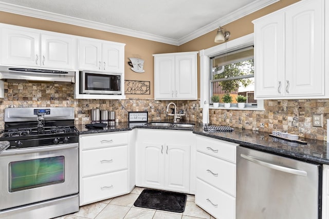 kitchen featuring appliances with stainless steel finishes, ornamental molding, white cabinets, a sink, and under cabinet range hood