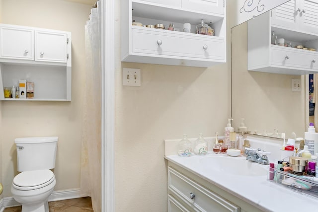 full bath with baseboards, vanity, toilet, and tile patterned floors