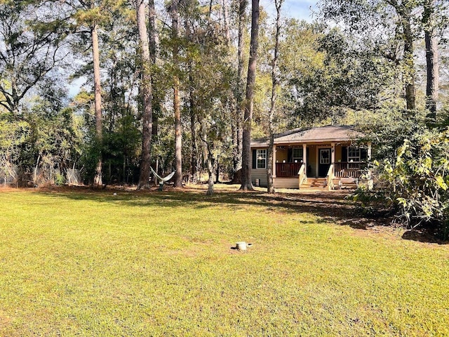 view of yard featuring covered porch