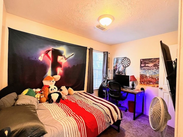 carpeted bedroom featuring a textured ceiling