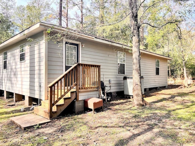 rear view of property featuring central AC