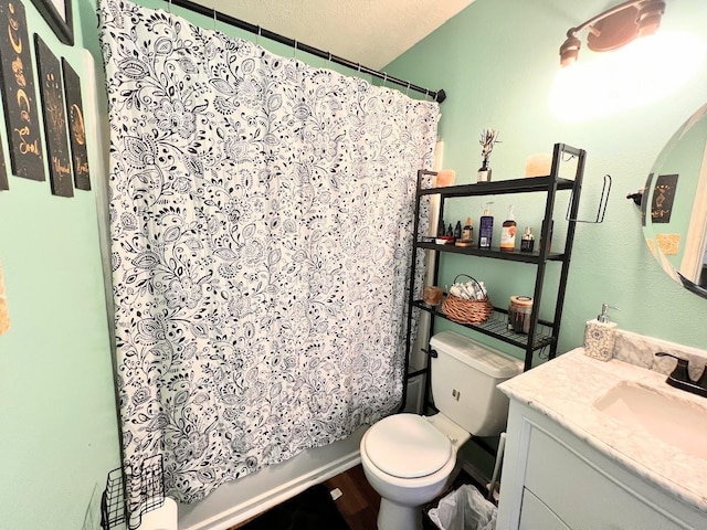 full bathroom featuring vanity, shower / bath combination with curtain, toilet, and a textured ceiling