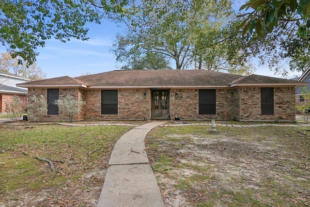 single story home with french doors and a front yard