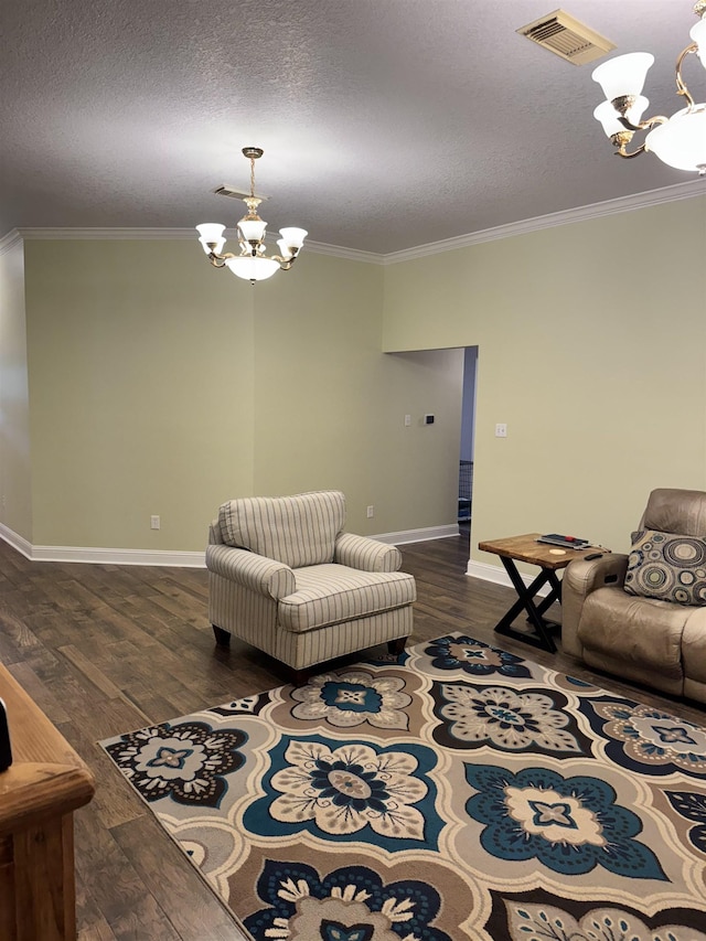 205 N Mayhaw Dr, Vidor, TX 77662 - living area with a chandelier, crown molding, dark wood-style flooring, and a textured ceiling