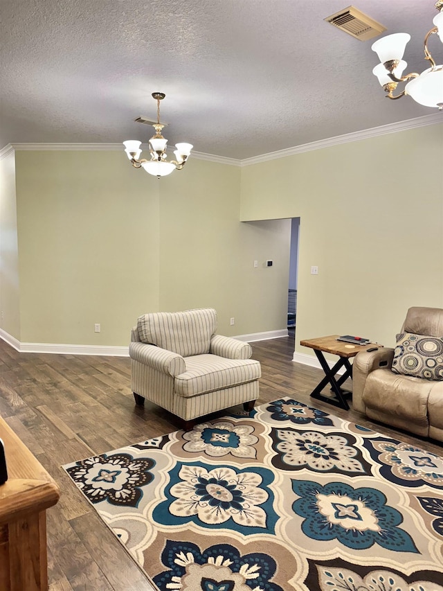 205 N Mayhaw Dr, Vidor, TX 77662 - living room with a chandelier, ornamental molding, wood finished floors, and a textured ceiling