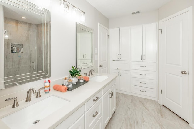 bathroom featuring vanity and a shower with door