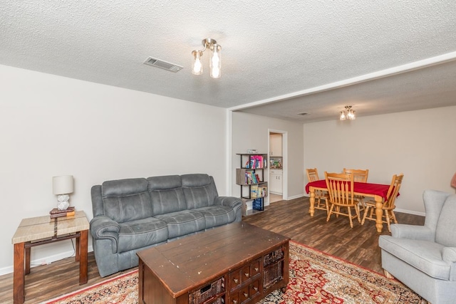 living room with wood-type flooring and a textured ceiling