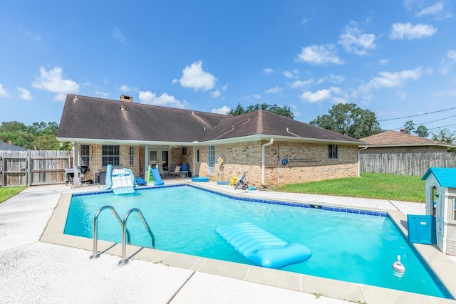 view of swimming pool with a patio area