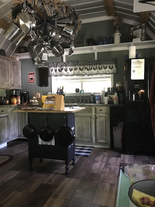 kitchen featuring dark hardwood / wood-style flooring, sink, and black fridge with ice dispenser