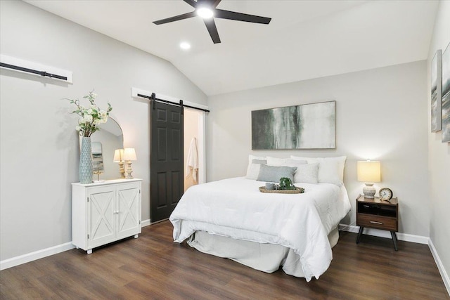 bedroom with ceiling fan, a barn door, dark wood-style flooring, baseboards, and vaulted ceiling