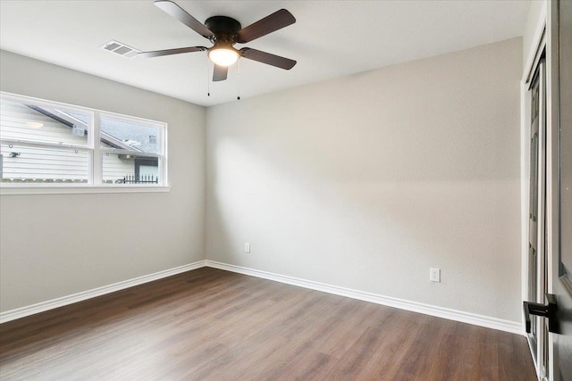 unfurnished bedroom featuring wood finished floors, visible vents, a ceiling fan, baseboards, and a closet