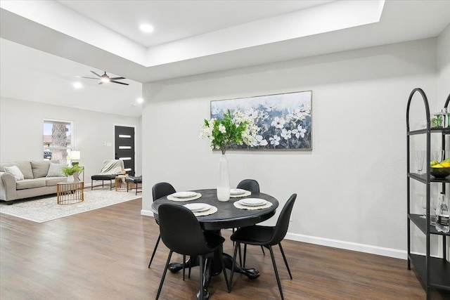 dining area with vaulted ceiling, dark wood finished floors, a ceiling fan, and baseboards