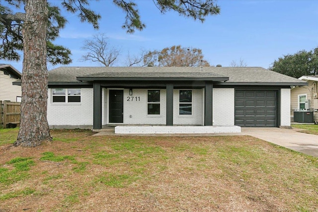 ranch-style house featuring central AC, a garage, and a front lawn