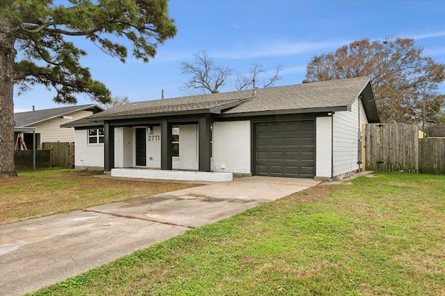 view of front facade featuring driveway, a garage, brick siding, fence, and a front yard