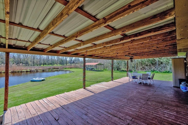 wooden terrace with a lawn and a water view