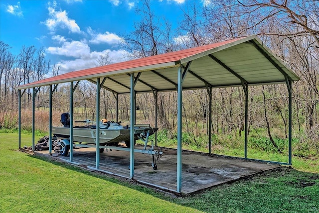 surrounding community with a detached carport, a lawn, and a wooded view