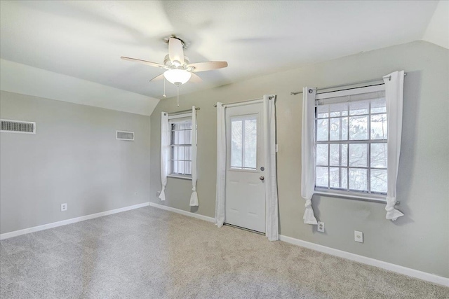 entryway featuring visible vents, ceiling fan, and vaulted ceiling