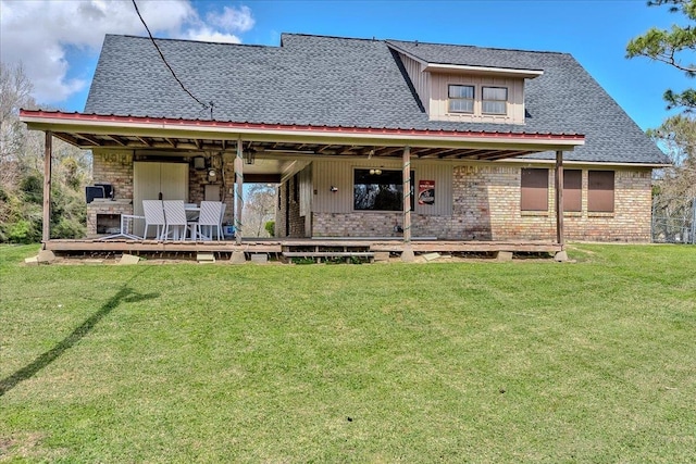 back of house featuring a yard and brick siding