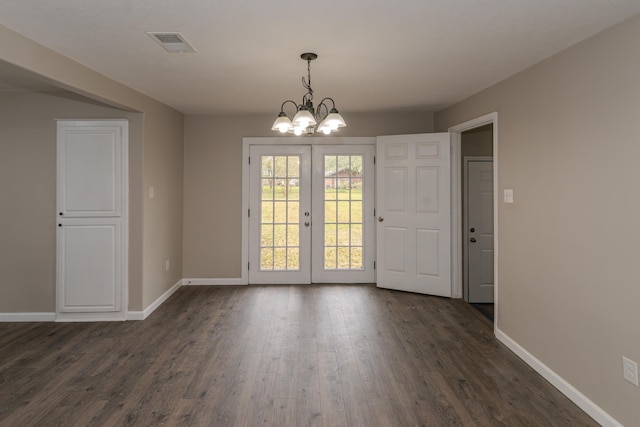 895 Morning Glory Dr, Bridge City, TX 77611 - unfurnished dining area with dark wood finished floors, baseboards, visible vents, and french doors