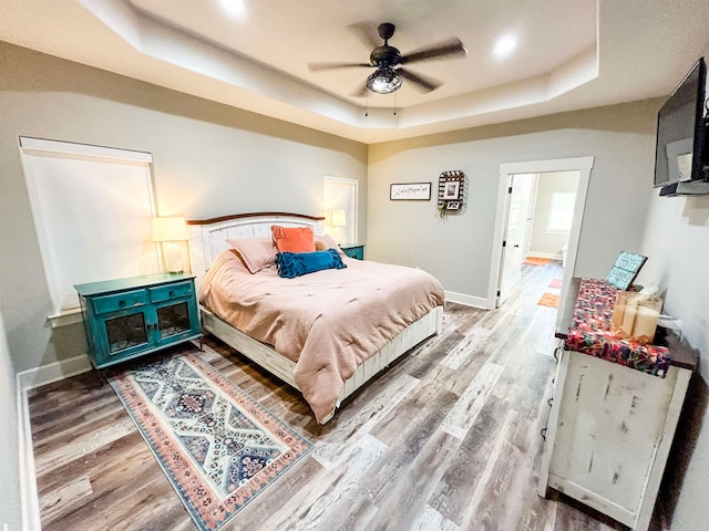 4885 Silver Leaf Dr, Orange, TX 77630 - bedroom with a raised ceiling, wood finished floors, and a ceiling fan