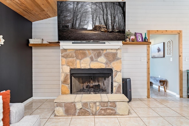 details with baseboards, a stone fireplace, wood walls, and wooden ceiling