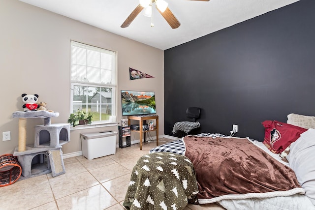 bedroom featuring light tile patterned floors, baseboards, and ceiling fan