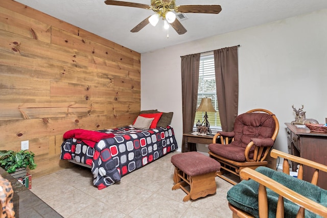 bedroom featuring wooden walls and a ceiling fan