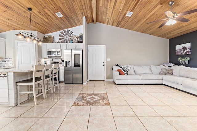 living area featuring light tile patterned floors, visible vents, and wood ceiling