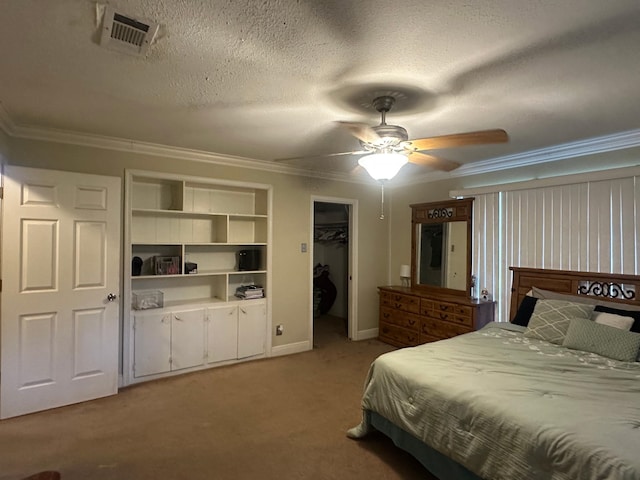 bedroom with crown molding, light colored carpet, visible vents, and a textured ceiling