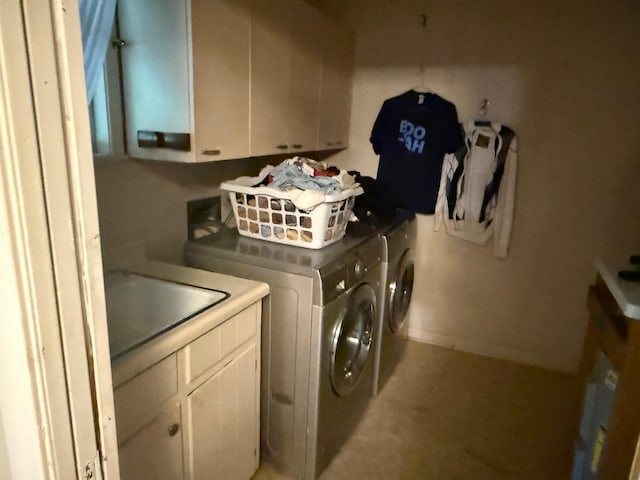laundry room with separate washer and dryer, baseboards, a sink, and cabinet space