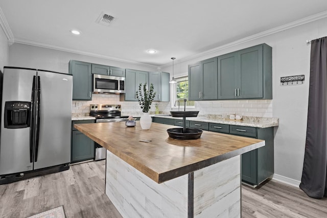 kitchen featuring appliances with stainless steel finishes, wooden counters, ornamental molding, light wood-style floors, and tasteful backsplash