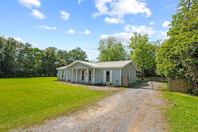 bungalow featuring driveway, a gate, metal roof, and covered porch