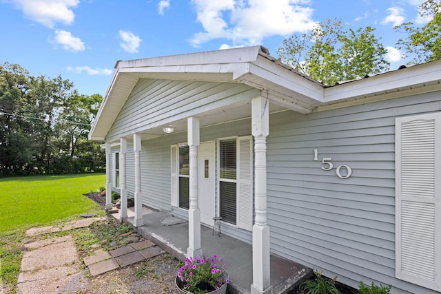 view of property exterior featuring a lawn and covered porch