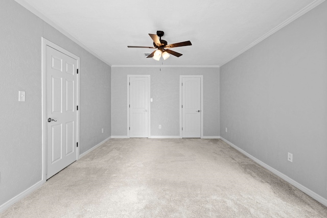 unfurnished bedroom with ornamental molding, light colored carpet, baseboards, and ceiling fan
